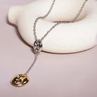 Lariat Necklace in Puffed Mariner Silver Gold Charm styled on a soft-toned background