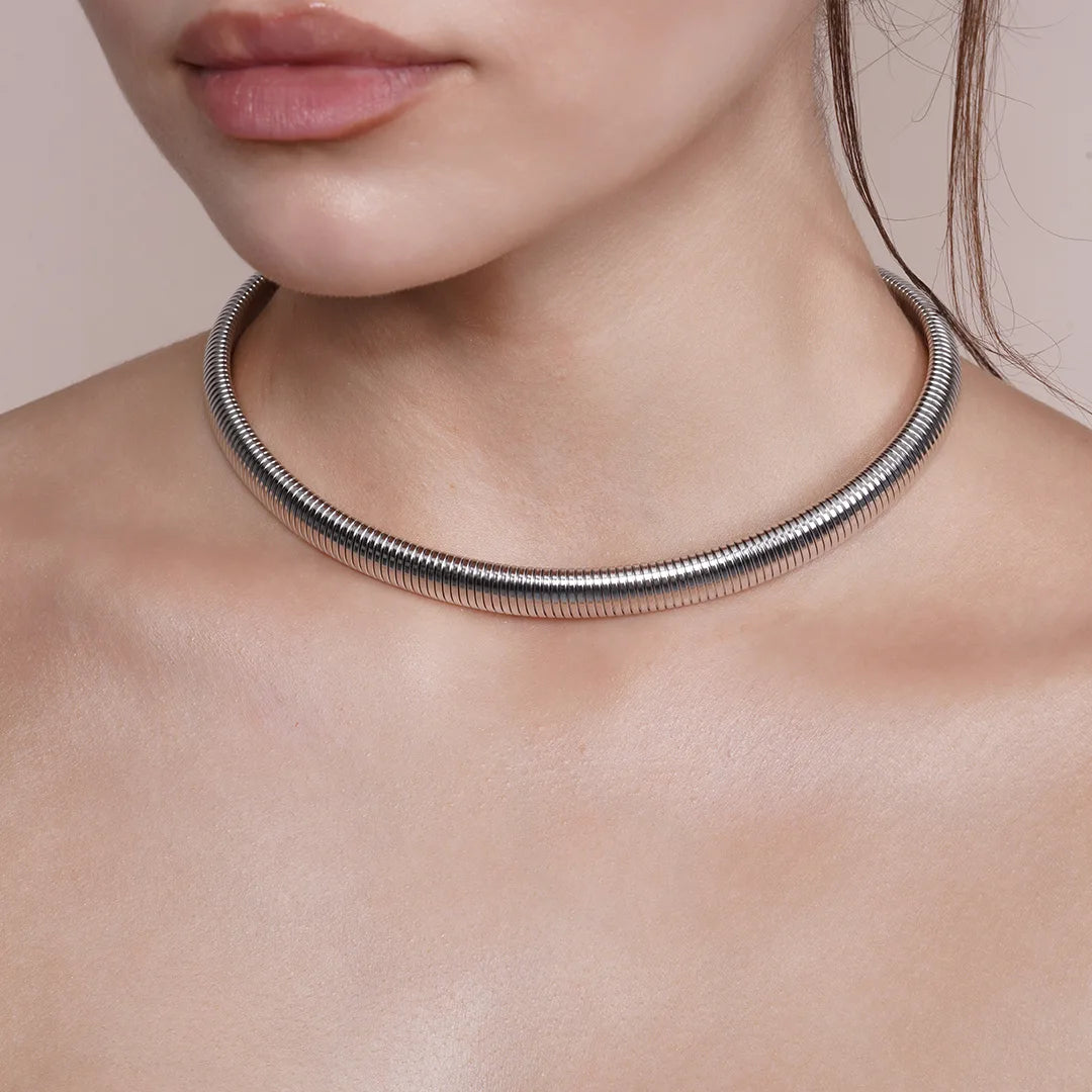 Model wearing Omega Chain Chunky Choker Necklace in Gold and Silver around her neck, alternate pose