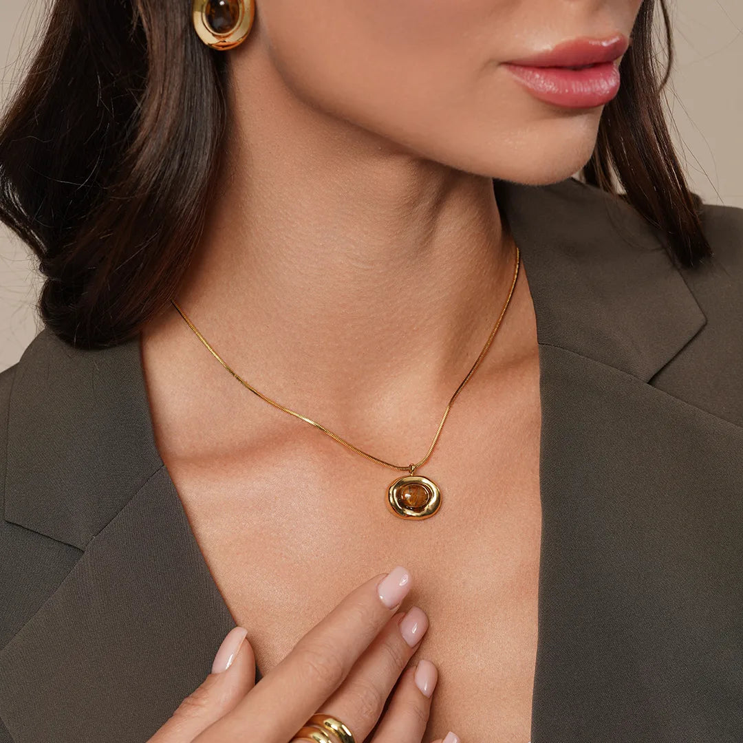 Model wearing Tiger Eye Oval Pendant Necklace around her neck, alternate pose
