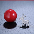 Snowflake and Reindeer Red Bead Christmas Asymmetric Stud Earring styled on a soft-toned background